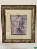 Front view of one framed print showing classical female face in sketch style with ornate gold-tone carved frame and cream matting.