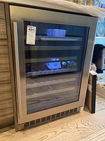 Front view of wine fridge with closed glass door showing digital temperature display