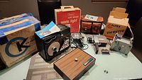 Full lot showing Argus 811 camera, leather case, Keystone projector, Sears movie light, Alpex editor all on display