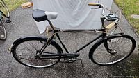 Full side view of men's black and white Skyway bicycle showing the frame, wheels, and overall condition.