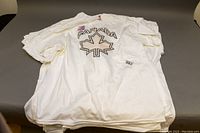 Stack of white Solar-T Canada T-shirts showing overall quantity and condition