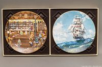 Two vintage Royal Doulton collector plates in original display boxes, one featuring a ship and the other a general store scene.