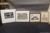 Four framed art pieces including a numbered black and white photo and three sketches, all signed and framed, laid out side by side.