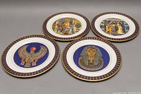 Four limited edition Treasures of Tutankhamen collector plates arranged flat to show designs