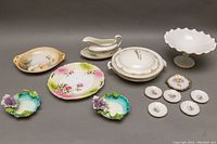 Overhead wide view of all items showing the assorted chinaware including plates, pedestal bowl, serving bowl, sauce boat, and mint dishes.