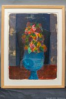 Frontal photo of framed colorful abstract floral print with blue vase on dark background with gold patterns.