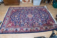 Full view of rug laid flat on floor showing overall design and color scheme