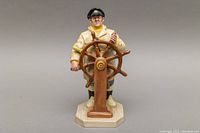 Front view of the Royal Doulton porcelain figurine The Helmsman HN-2499 showing detailed facial features, maritime uniform, and ship's wheel.
