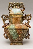 Front view of two-piece jade vessel showing square body, lid, handles and rings.