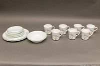 Full lot view showing all plates and mugs arranged in a single photo
