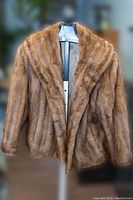Front view of vintage mink fur jacket on mannequin, showing rich brown fur and classic collar design