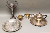 Photo showing the vintage silver plated etched vase, three-piece tea set and two trays with visible tarnish and minor wear.