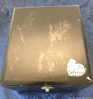 Closed black case with scuffed gold finish, sticker showing Made in Czechoslovakia.