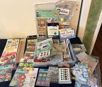 Photo of the closed 12x12 plastic case filled with various scrapbooking materials including stickers and books.