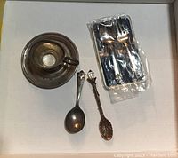 Full lot of silver and copperware including silver saucer, loving cup, 3 spoons and 1 fork, baby spoon and fork in original plastic case.