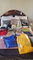Overview of all purses and bags on bed