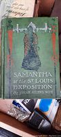 Front cover of antique hardcover book showing title and embossed artwork.