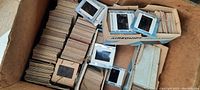 Box containing over 100 antique photographic slides in paper and plastic mounts related to teaching and school scenes