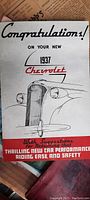 Front cover of the 1937 Chevrolet brochure featuring illustration of a car grille and congratulatory text.