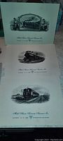 Four unframed vintage railroad prints featuring steam locomotives and railroad scenes arranged in a row showing black and white detailed illustrations with decorative frames and text captions.