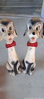 Pair of ceramic dog-shaped salt and pepper shakers with red collars labeled S and P