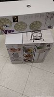Boxes of 3-tier market basket and 3 pack GE LED spheres stacked