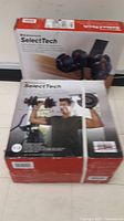 Front view of two boxed Bowflex SelectTech 552 dumbbells strapped together