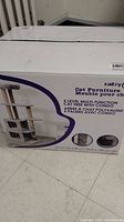Box front showing product name and brand Catry, with visuals indicating a cat tree with multiple levels and condo.