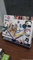 Front view of the unopened Mini Disney Store Mini Brands box showing the set contents and character images.