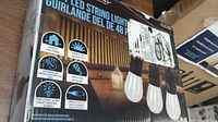 Box showing product information and features such as outdoor use, warm white light, shatterproof bulbs, heavy duty cable, energy efficiency, and compatibility with multiple sets.