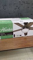 Front view of sealed Hunter Brenham ceiling fan box on table