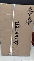 Front panel of sealed box with Teeter logo and straps
