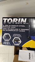 Box packaging front showing TORIN brand and specifications including 3 ton capacity and lifting height range
