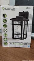 Front image of box showing Good Earth Lighting outdoor wall lantern model with product image and branding.