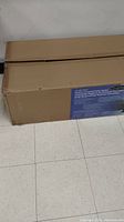 Long cardboard box containing heater unassembled