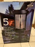 Original box for 5-pack vintage style solar LED pathway lights in black with branding and features