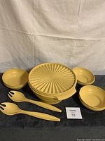 Set showing large salad bowl stacked with lid and six smaller bowls