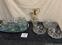 Full lot front view showing the tray with 12 liqueur glasses, the decanter, and three cut glass dishes arranged on fabric background.