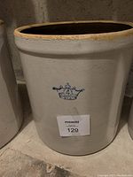 Front view of vintage stoneware crock, showing Blue Crown Ransbottom 4 gallon blue crown mark.