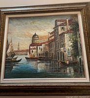 Full view of the framed Venice scene oil painting showing boats and buildings along the canal with a dome structure in the background.