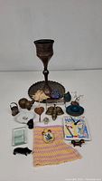 Image showing entire lot of decorative items including brass chalice, snuff bottle, tile clock, figurines, and other small objects.