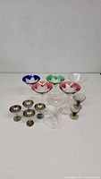 Photo showing all stemware items including colored cut crystal martini glasses, smokey glass sherbets, and silver plated coupes
