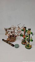 Overall group shot of bird decorative items including the wooden bird tree, Mexican bird candlesticks, decorative tube, and small container.