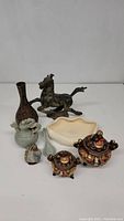 Group of seven decorative items including bronze horse, vase, dragon pitcher, dish, bird figurine and two detailed incense burners