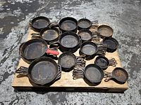 Overall pallet view showing all cast iron skillets stacked and arranged