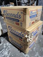 Stack of three cardboard boxes labeled 5 Seconds Disinfectant Wipes, showing some damage from claws but packaging intact.