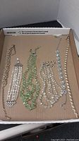 All six jewelry pieces displayed in cardboard box