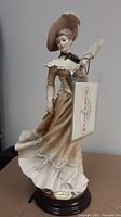Front view of the full figurine on its wooden base