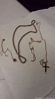 Four necklaces arranged on light surface