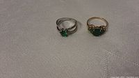 Two rings side by side on white textured cloth